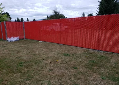 chain link fence with red inserts