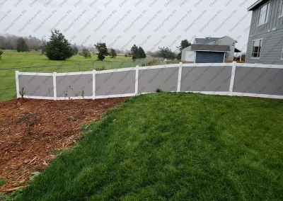 Residential two-toned contour vinyl fence