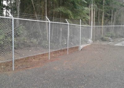 Galvanized 6 foot tall, utility fencing with three strands of Barbwire